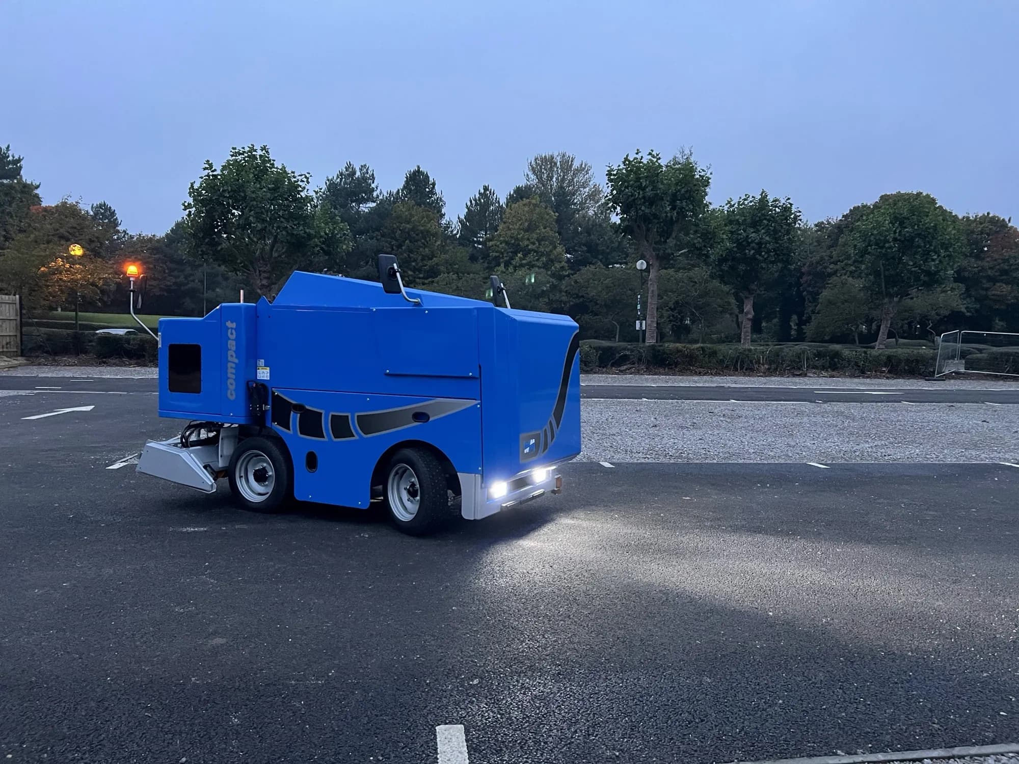 An ice resurfacer working the rink at night