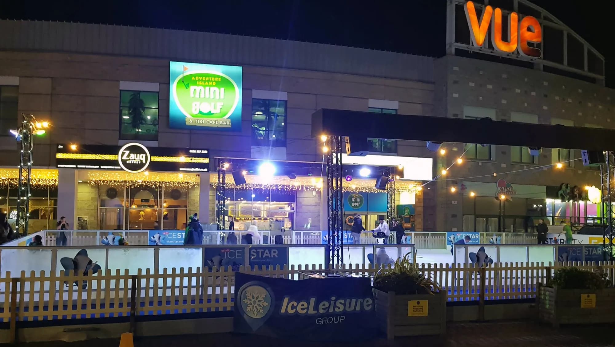 The StarCity rink at night beside the cinema